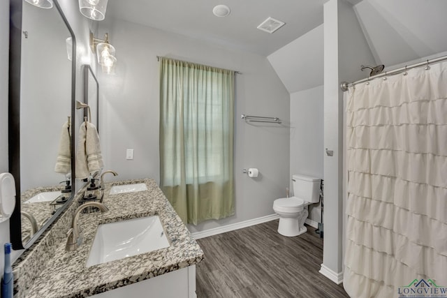 bathroom featuring a shower with curtain, vaulted ceiling, toilet, vanity, and hardwood / wood-style flooring