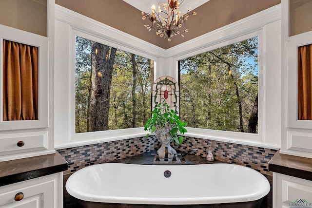 bathroom featuring a tub to relax in and an inviting chandelier