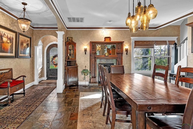 dining area featuring ornamental molding and a tile fireplace