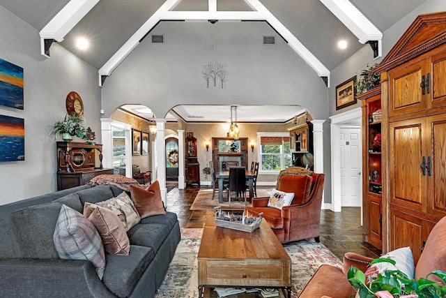 living room with beam ceiling, ornate columns, and high vaulted ceiling