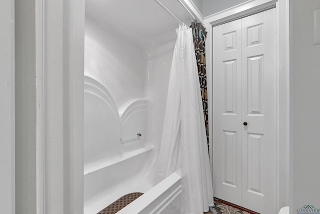 bathroom with shower / bath combination with curtain