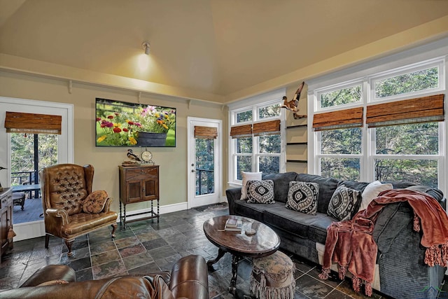 living room with plenty of natural light and high vaulted ceiling