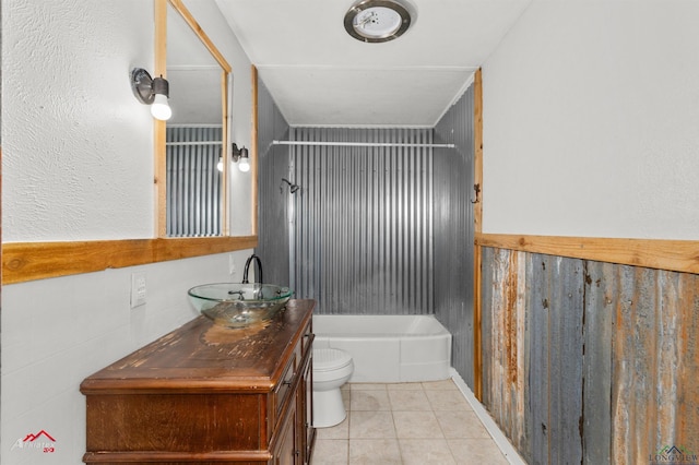 full bathroom featuring toilet, vanity, tile patterned flooring, and shower / washtub combination