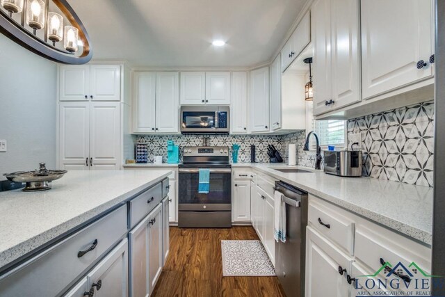 3610 Lakeshore Dr, Weatherford, TX 76087 - kitchen featuring stainless steel appliances, a sink, dark wood-type flooring, white cabinets, and decorative backsplash