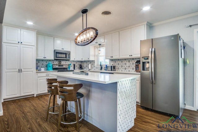 3610 Lakeshore Dr, Weatherford, TX 76087 - kitchen featuring stainless steel appliances, crown molding, white cabinets, tasteful backsplash, and dark wood-type flooring