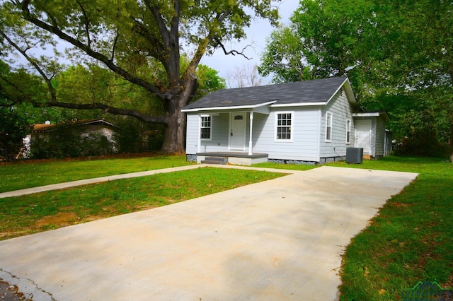 view of front facade with central AC and a front lawn