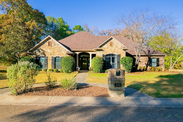 ranch-style home with a front lawn