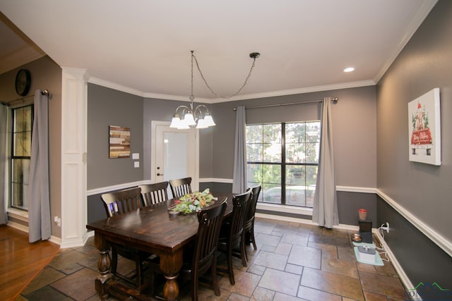 dining space with a chandelier and crown molding