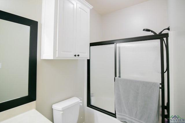 bathroom with shower / bath combination with glass door and toilet