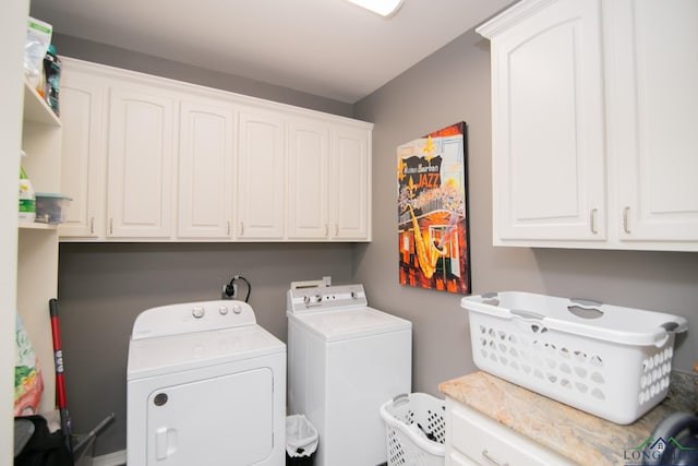 washroom with cabinets and separate washer and dryer