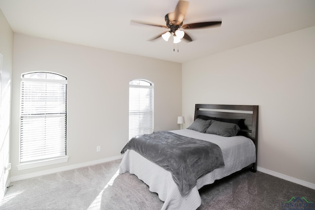 bedroom featuring multiple windows, ceiling fan, and carpet floors