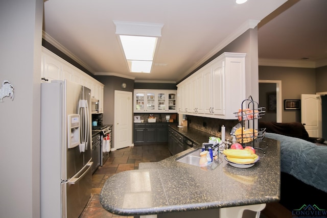 kitchen featuring white cabinets, kitchen peninsula, stainless steel appliances, and ornamental molding