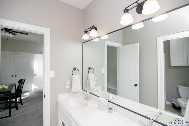 bathroom with vanity, toilet, and ceiling fan