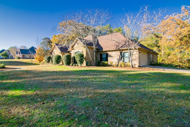 ranch-style home featuring a front lawn and a garage