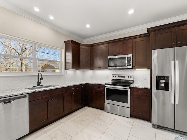 kitchen with stainless steel appliances, sink, backsplash, light stone countertops, and crown molding