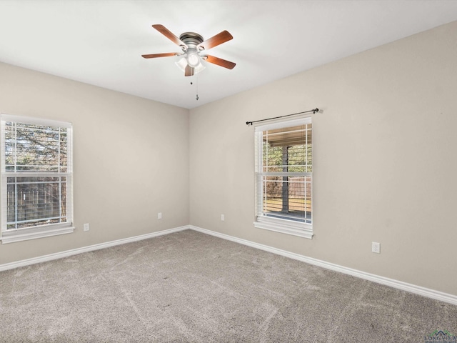 carpeted spare room featuring ceiling fan