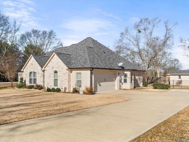 french country inspired facade with a front yard and a garage