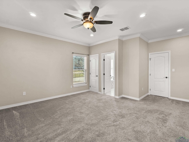 carpeted empty room with ceiling fan and crown molding