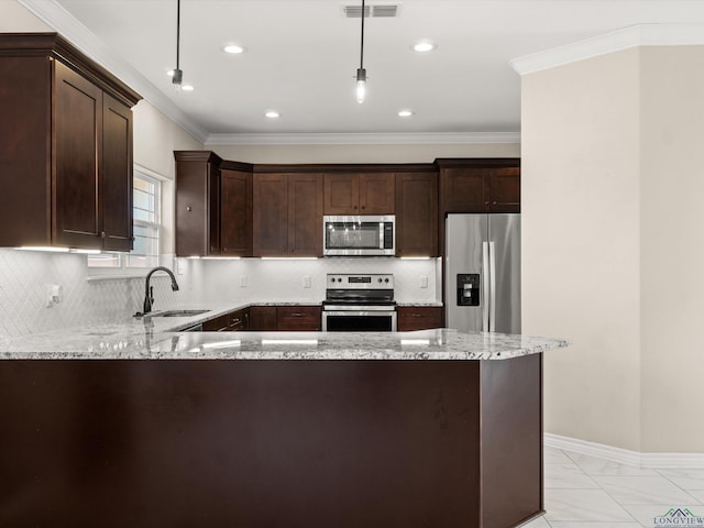 kitchen featuring stainless steel appliances, hanging light fixtures, kitchen peninsula, light stone countertops, and sink