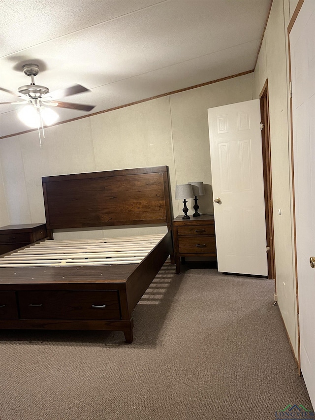 bedroom with carpet flooring, a textured ceiling, ceiling fan, and ornamental molding