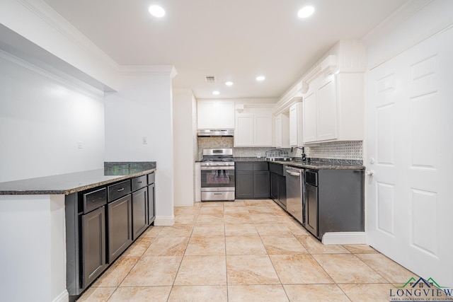 kitchen with white cabinetry, tasteful backsplash, dark stone countertops, kitchen peninsula, and appliances with stainless steel finishes