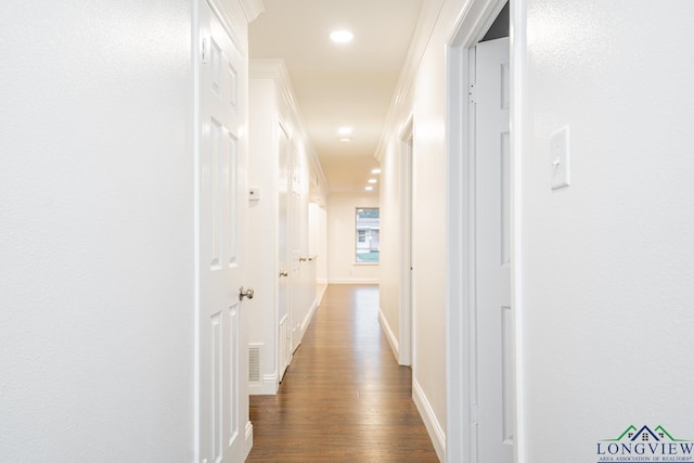 hallway with dark hardwood / wood-style floors and ornamental molding