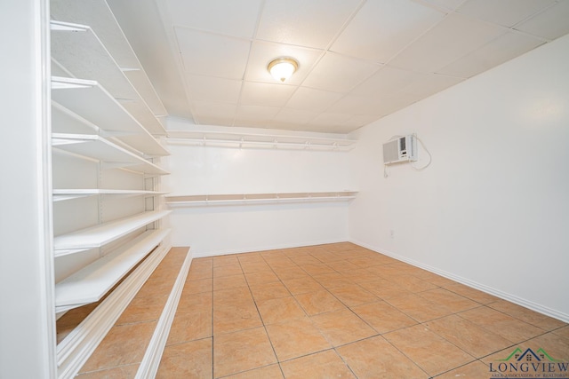 spacious closet with tile patterned flooring and an AC wall unit