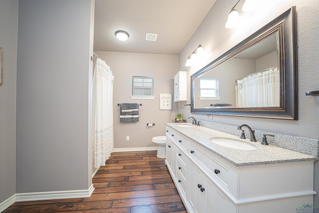 415 Bob White Dr, Gilmer, TX 75645 - full bath featuring wood-type flooring, double vanity, and curtained shower