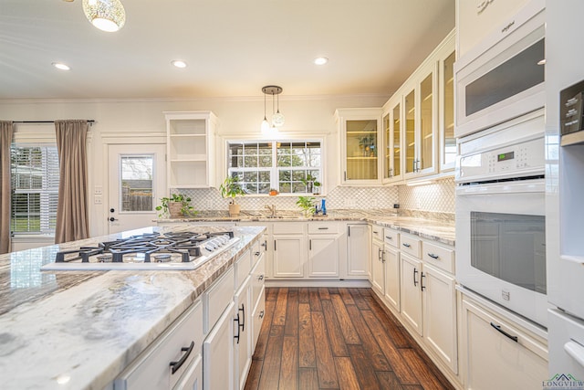 415 Bob White Dr, Gilmer, TX 75645 - kitchen with white appliances, dark wood-style flooring, crown molding, backsplash, and light stone countertops