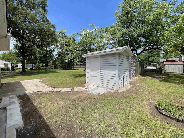 view of yard with a storage shed and an outdoor structure