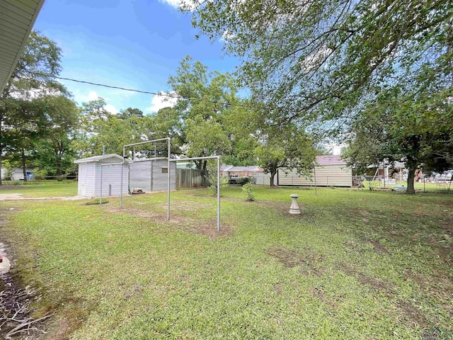 view of yard featuring a storage shed and an outbuilding