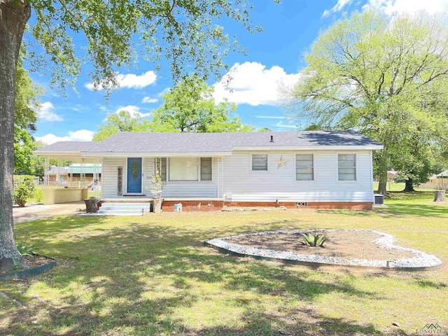 rear view of house with a lawn and a porch