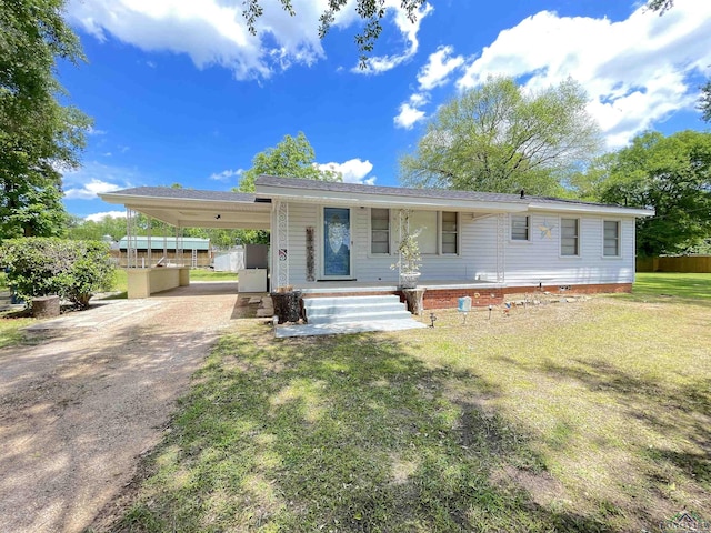 view of front of house with driveway, a front yard, an attached carport, and a porch