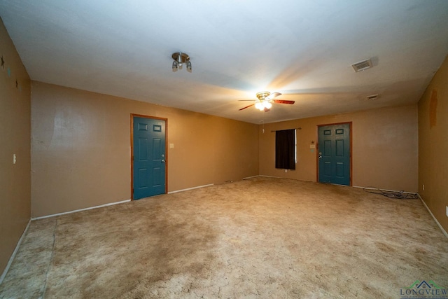 carpeted empty room with a ceiling fan and visible vents