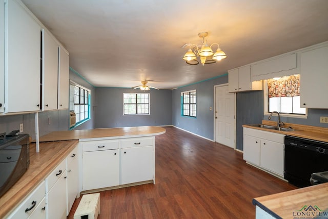 kitchen featuring a peninsula, dark wood-style flooring, a sink, dishwasher, and plenty of natural light