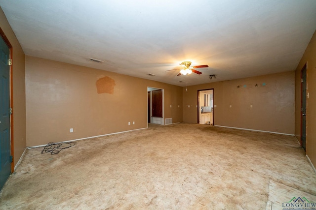 spare room featuring visible vents, ceiling fan, and baseboards