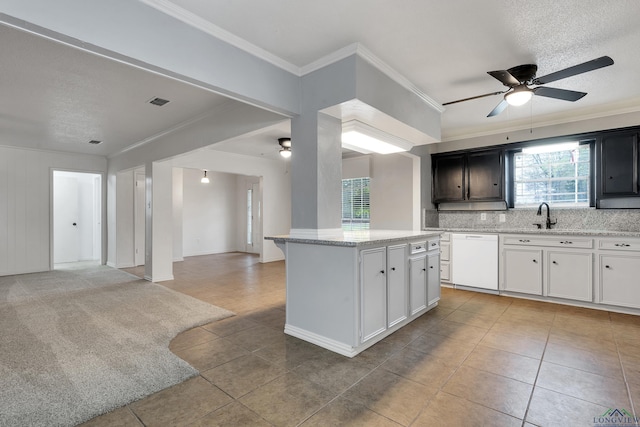 kitchen featuring ceiling fan, a center island, dishwasher, crown molding, and white cabinets