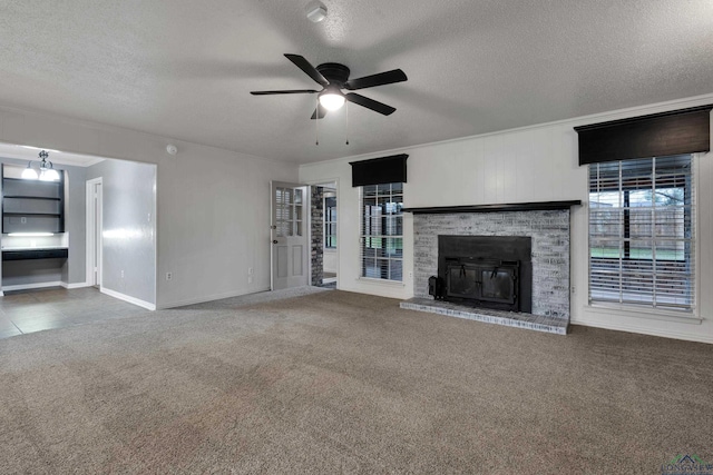 unfurnished living room featuring dark colored carpet, a textured ceiling, ceiling fan, and a fireplace