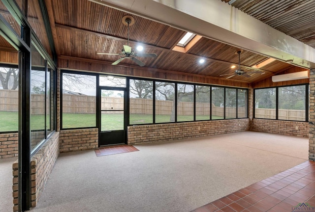 unfurnished sunroom featuring a skylight, ceiling fan, and wood ceiling