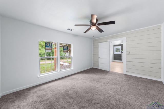 913 Church St, Winnsboro, TX 75494 - unfurnished bedroom featuring multiple windows, carpet flooring, baseboards, and a ceiling fan