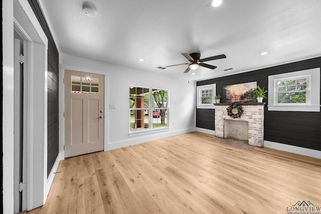 913 Church St, Winnsboro, TX 75494 - unfurnished living room featuring baseboards, wood finished floors, ceiling fan, recessed lighting, and a fireplace