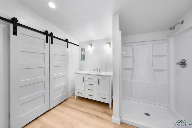 913 Church St, Winnsboro, TX 75494 - full bathroom with a stall shower, wood finished floors, and vanity