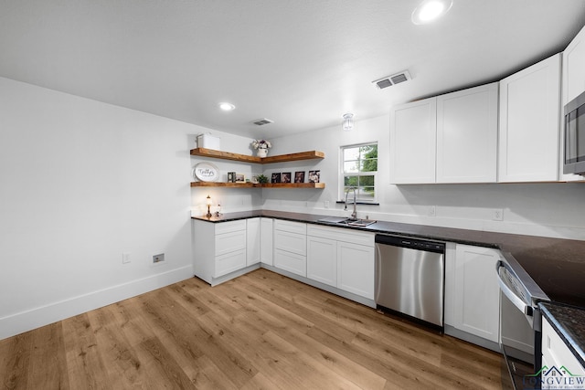 913 Church St, Winnsboro, TX 75494 - kitchen featuring stainless steel appliances, a sink, open shelves, recessed lighting, and white cabinets