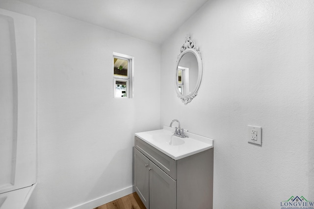 913 Church St, Winnsboro, TX 75494 - bathroom with vanity, wood finished floors, and baseboards