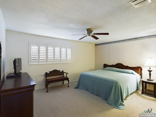 bedroom with a textured ceiling, light carpet, and ceiling fan
