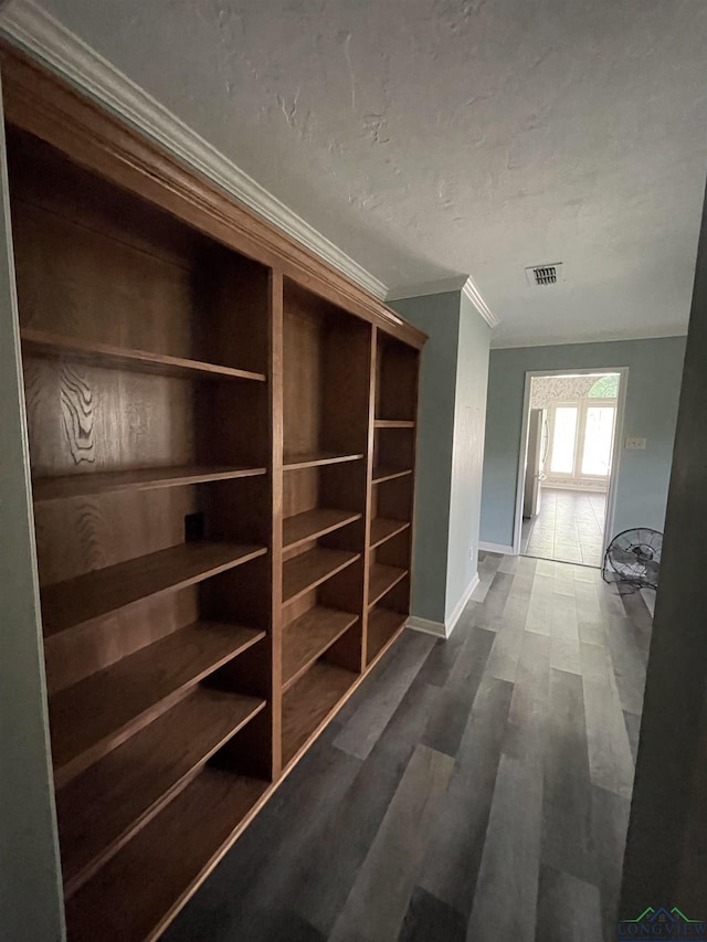 hall featuring crown molding and dark hardwood / wood-style flooring