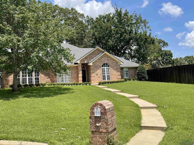 single story home featuring a front lawn