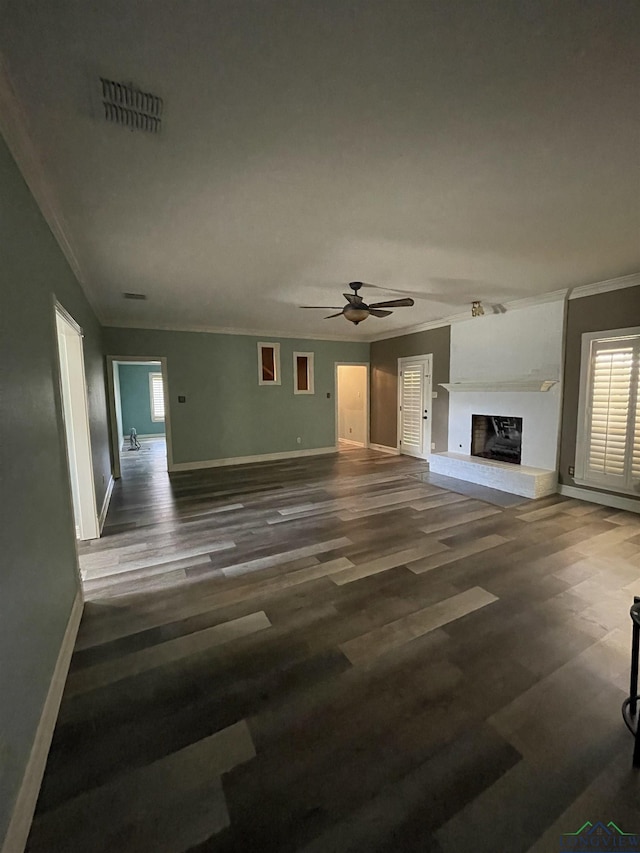 unfurnished living room with ceiling fan, dark wood-type flooring, and ornamental molding