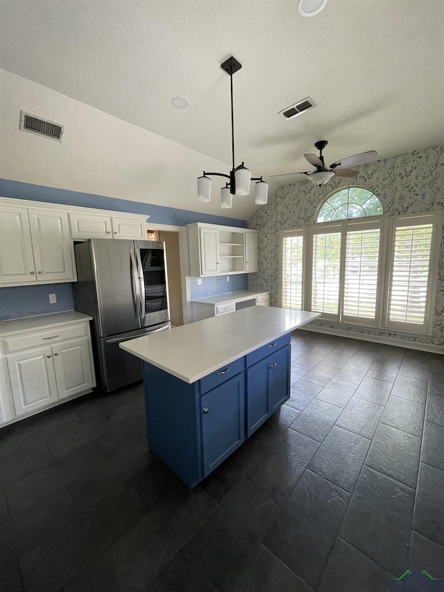 kitchen featuring stainless steel refrigerator, ceiling fan, white cabinets, and pendant lighting