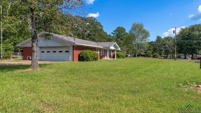 view of front of house with a garage and a front lawn